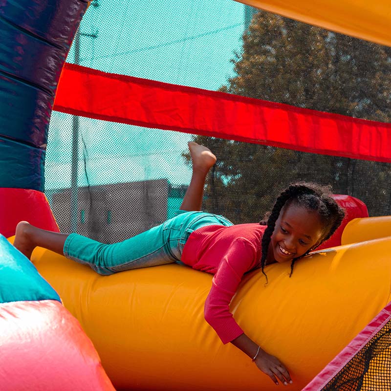 image of a young girl climbing in an inflatable obsticle course 