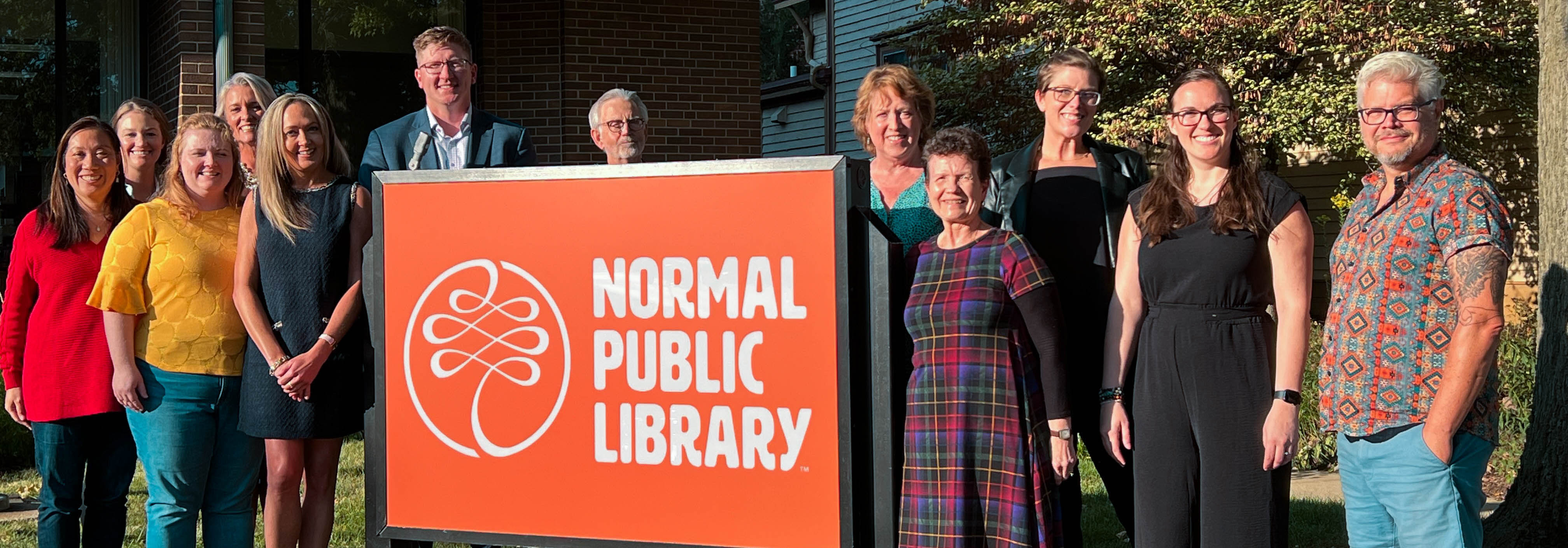 Normal Public Library Foundation Board posed with Normal Public Library sign