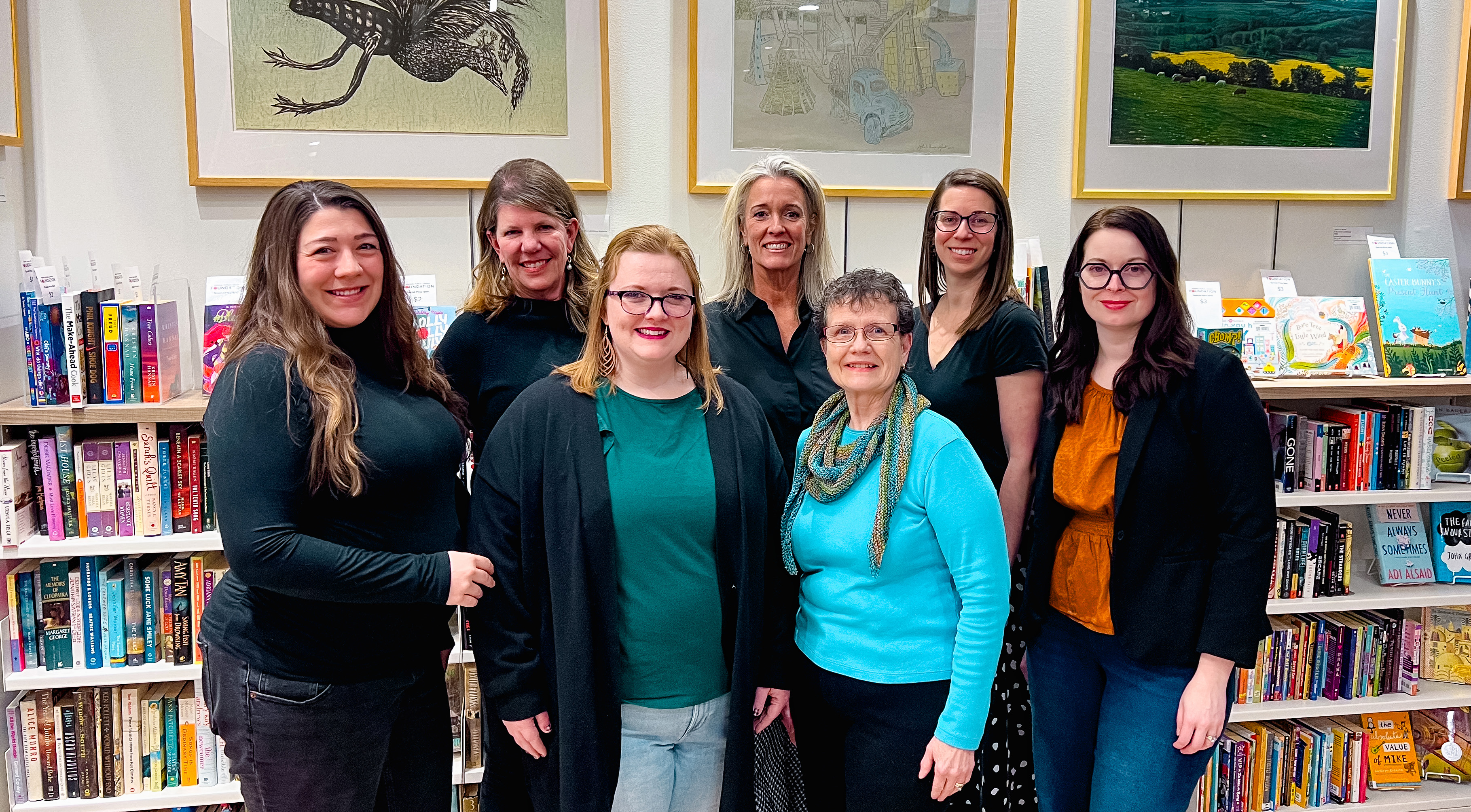 Image of a group of women standing in front of bookshelves