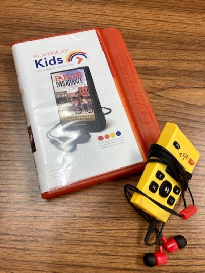 Image of Playaway device, Playaway container for The Parker Inheritance, and earbuds