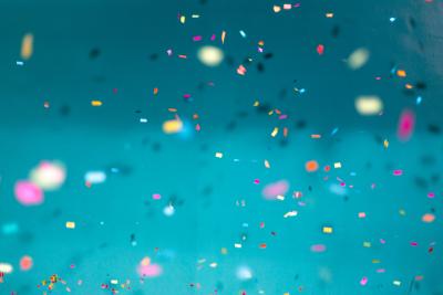 "Confetti against blue background" photo by Jason Leung on Unsplash