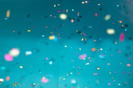 "Confetti against blue background" photo by Jason Leung on Unsplash