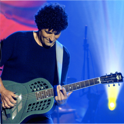 Chris Vallillo playing a vintage guitar onstage