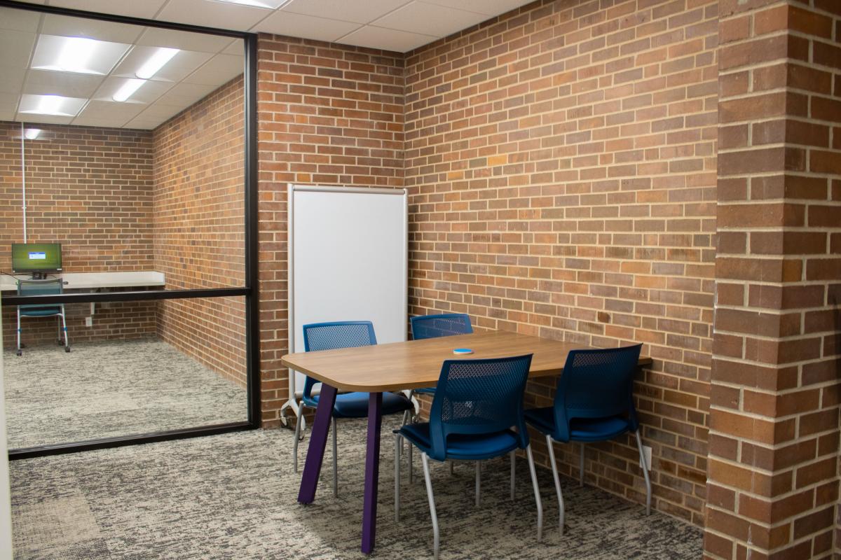 Work Space, area with work table, four chairs and a mobile dry erase board